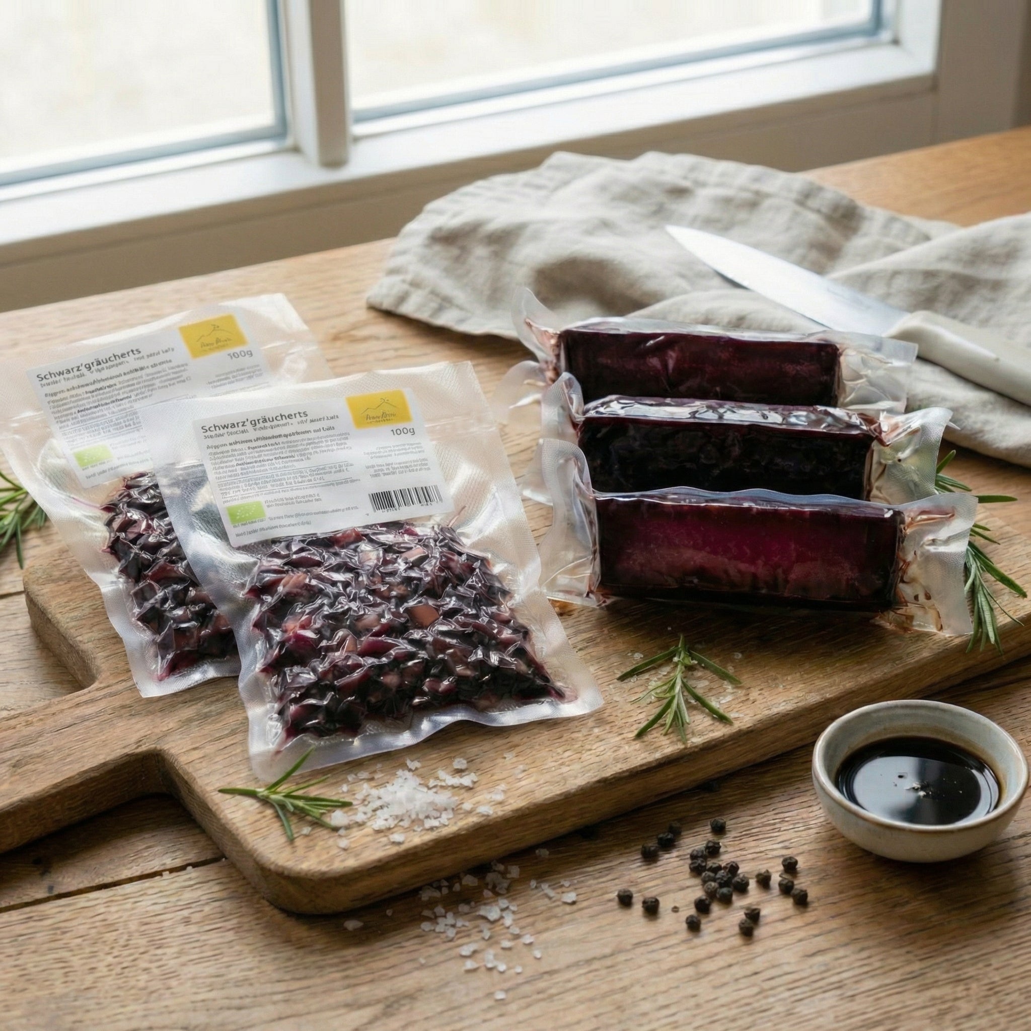 The Anna Meru Alpine Chef's Bundle featuring packaged vegan smoked blocks and cubes displayed on a rustic wooden board.